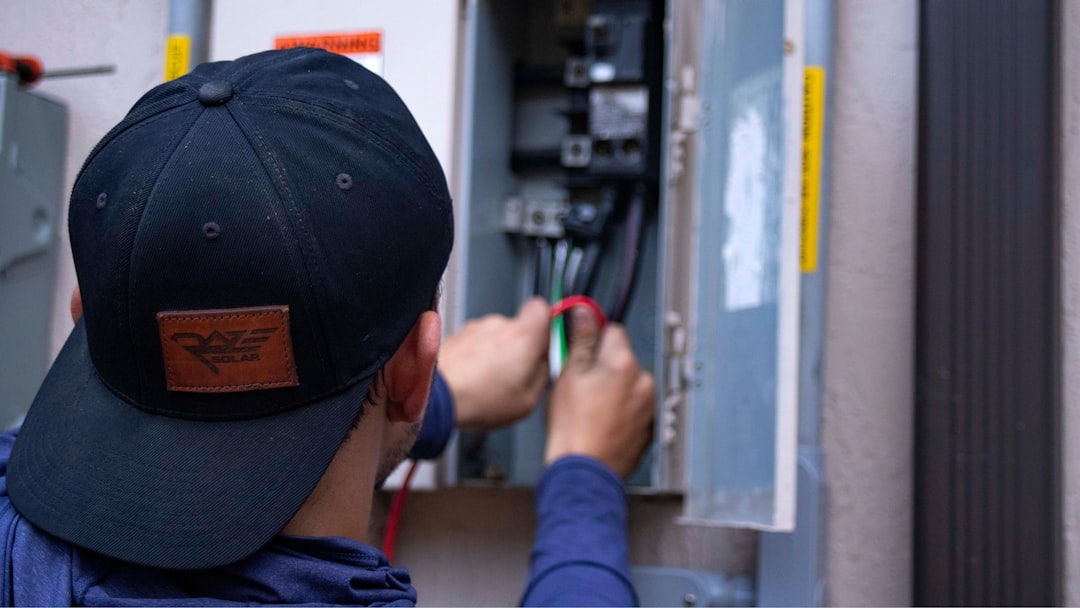 Professional electrician performing precision electrical work
